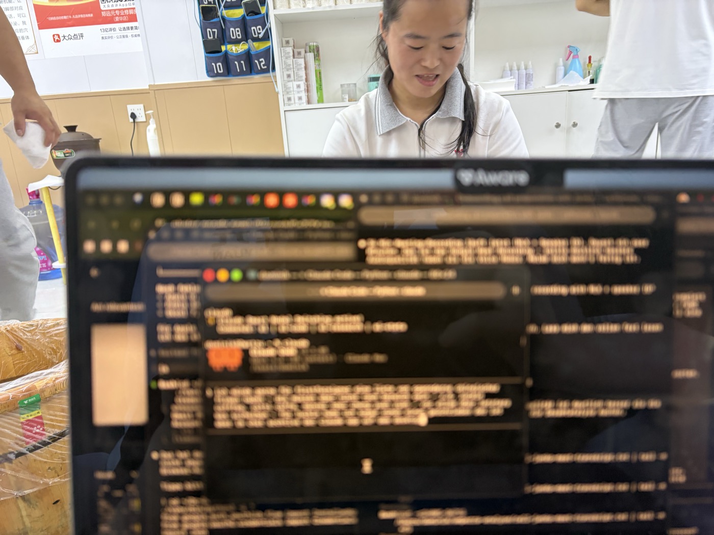 Technician working while laptop shows code