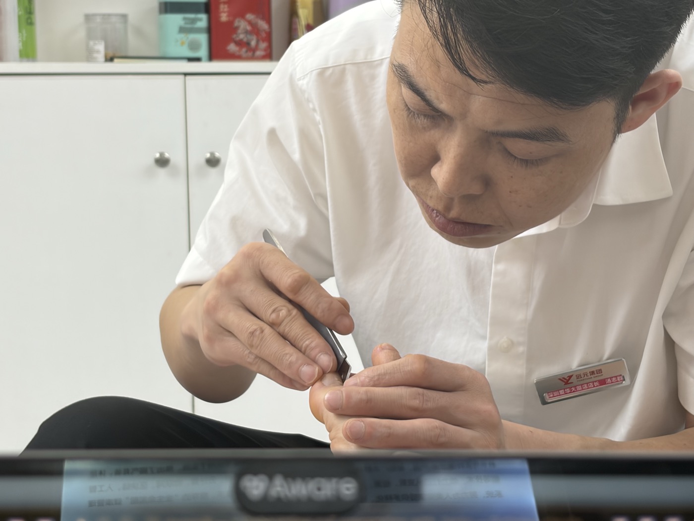 Male specialist performing precision scalpel work on ingrown toenail